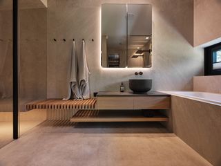 Modern bathroom with modern floating sink and shelves, marble pattern walls, floor, bath and shower