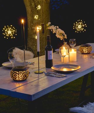 Twinkling lights on an wooden outdoor table