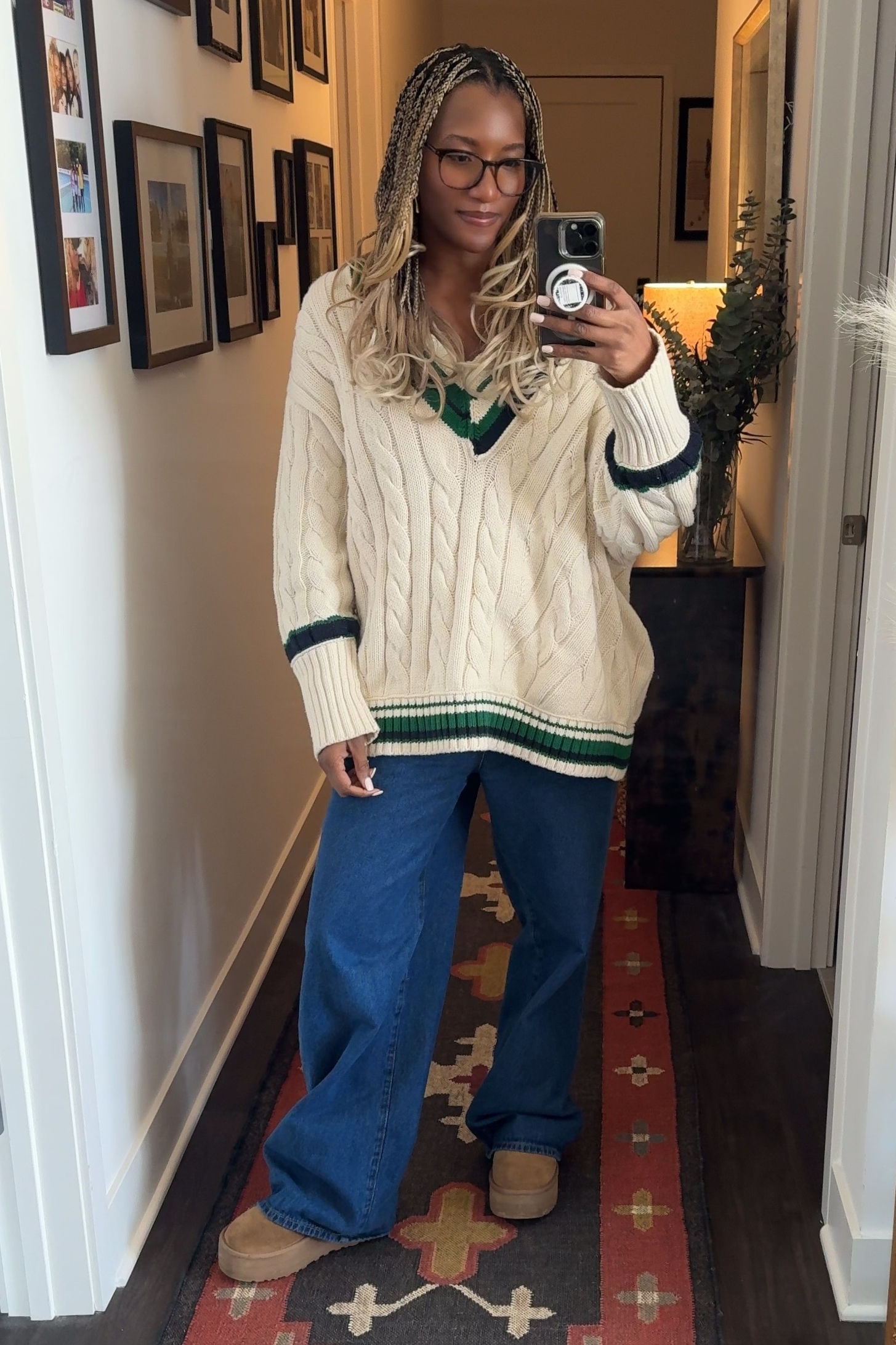 Danielle Prescod wearing a sweater, jeans, and uggs