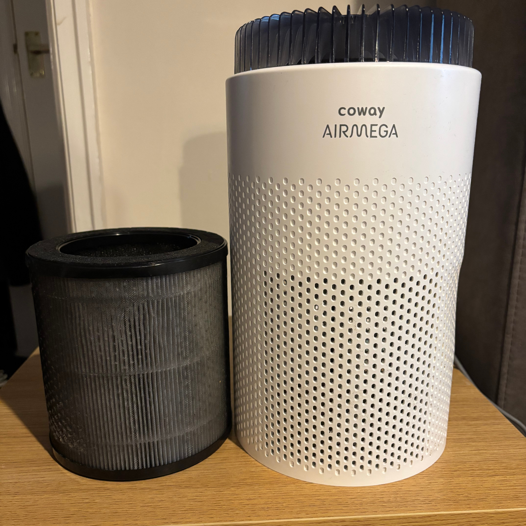 Air purifier and filter side by side on table