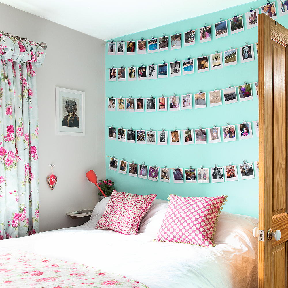 bedroom with feature wall, photographs and bed