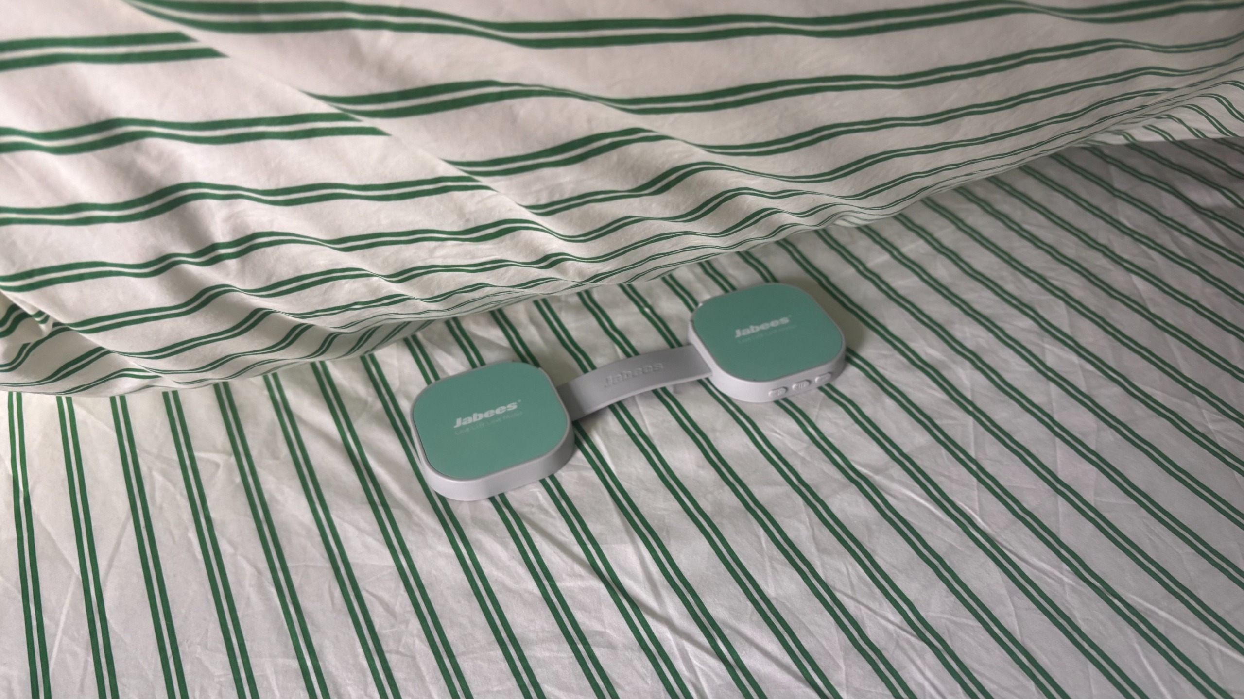 The Jabees PEACE Duo Pillow Speaker placed under a pillow.