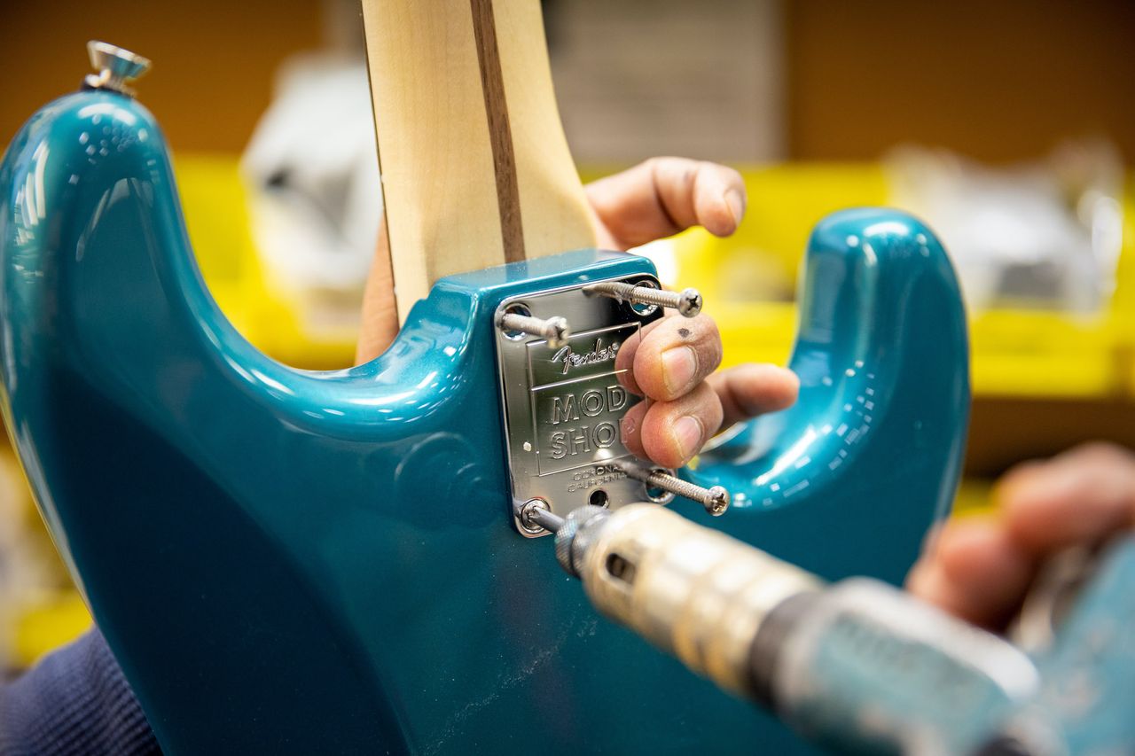 A technician works on a guitar at Fender's Mod Shop