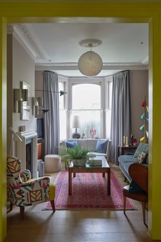 A yellow doorway leads into a living room