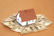 model house with a brown roof on one hundred dollar bills