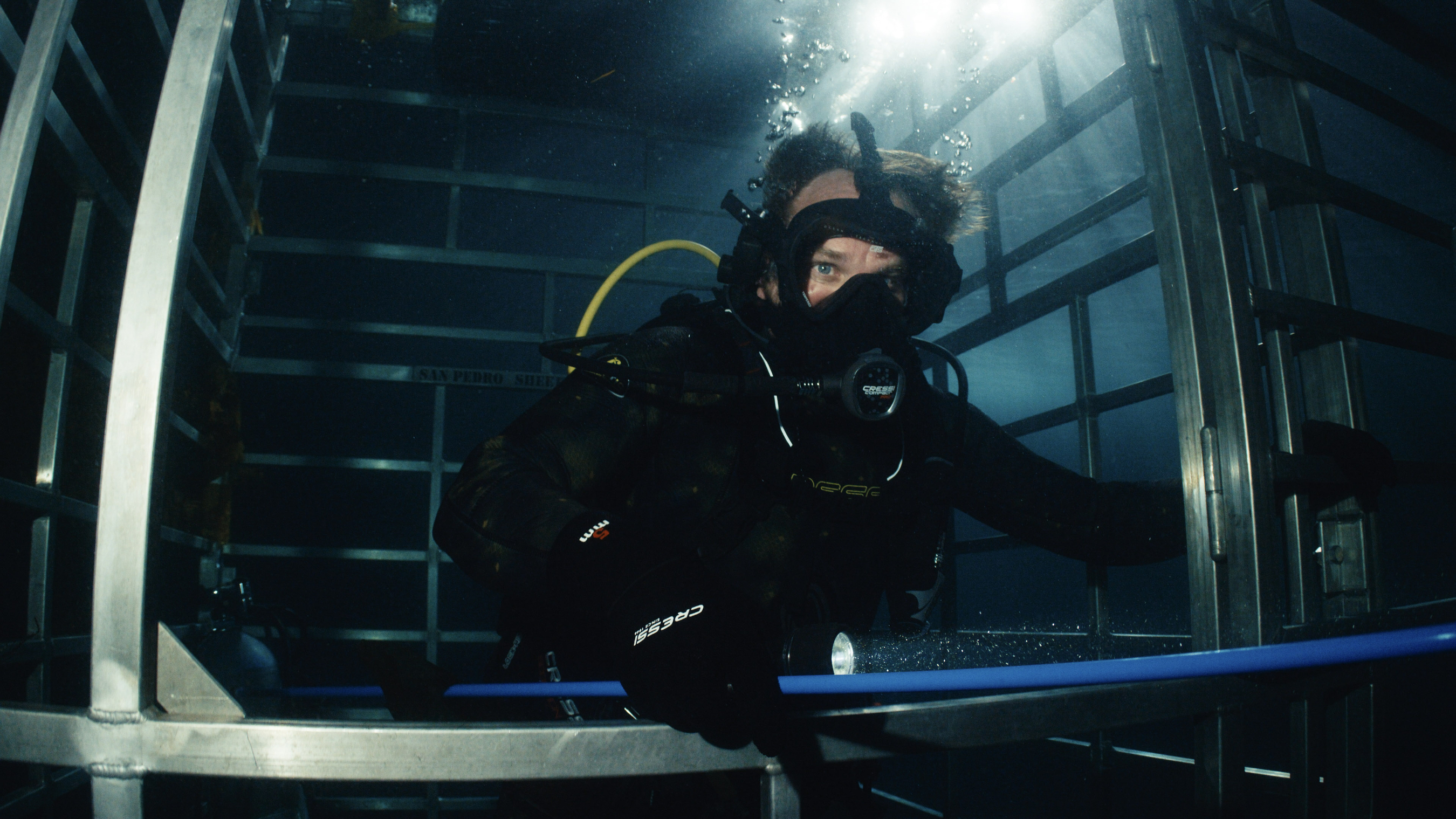 a man in a shark diving cage