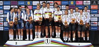 Riders from Switzerland celebrate with their gold medals and cow mascots after the Team Time Trial Mixed Relay road race during the UCI Cycling World Championships in Glasgow Scotland on August 8 2023 