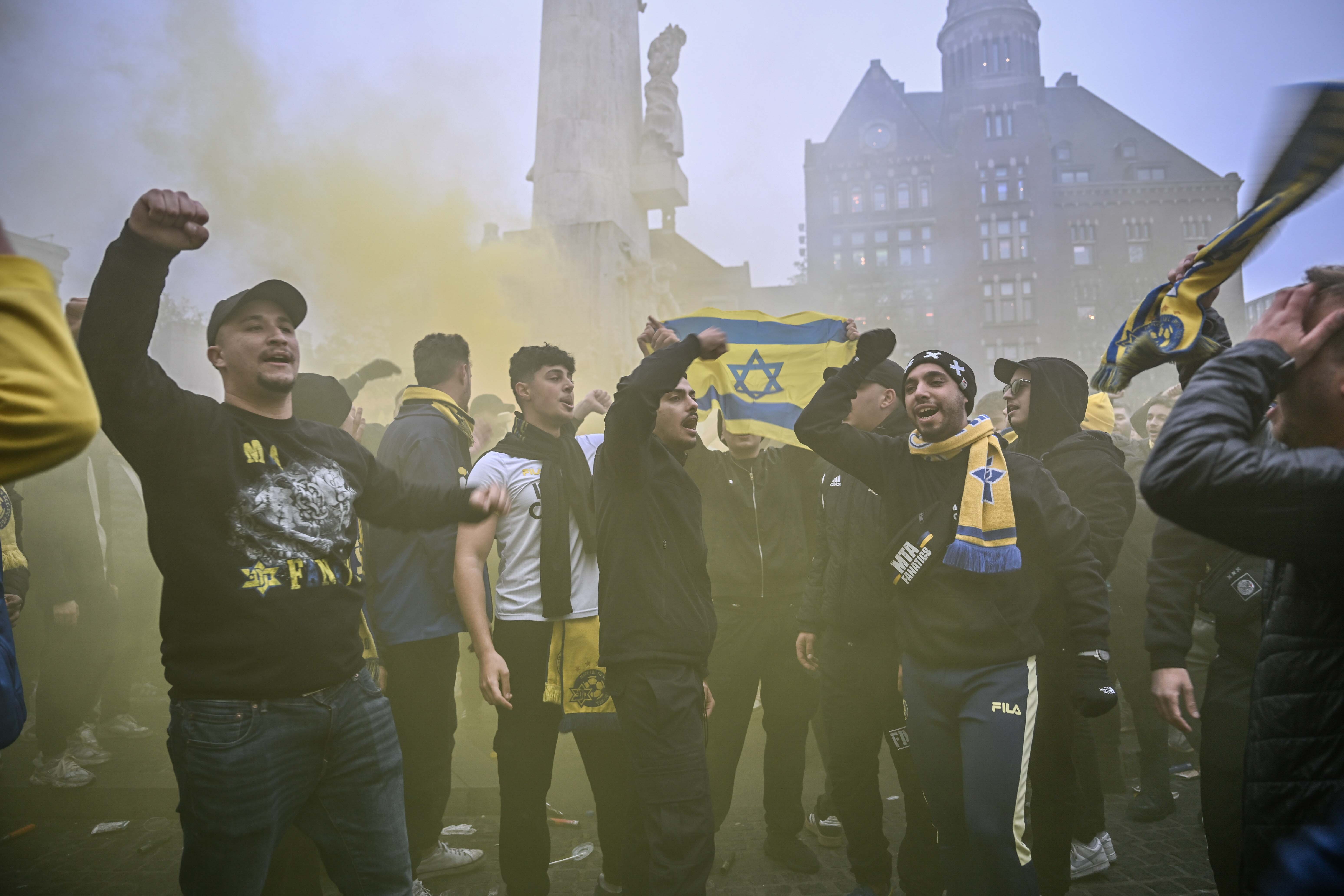 AMSTERDAM, NETHERLANDS - NOVEMBER 7: Fans of Maccabi Tel Aviv stage a pro-Israel demonstration at the Dam Square, lighting up flares and chanting slogans ahead of the UEFA Europa League match between Maccabi Tel Aviv and Ajax in Amsterdam, Netherlands on November 07, 2024. Maccabi fans clashed with pro-Palestinian citizens and ripped off Palestinian flags hung on the streets. In the lead-up to the Ajax vs Maccabi Tel Aviv match, several areas of Amsterdam have been designated as security risk zones. (Photo by Mouneb Taim/Anadolu via Getty Images)