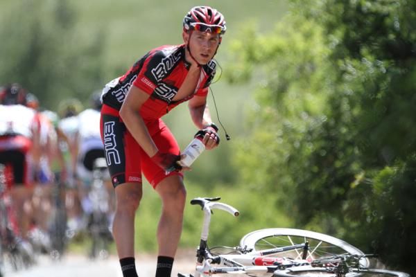BMC's Jackson Stewart collects his bidons while waiting for a bike exchange in stage four