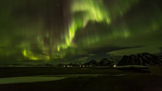 Northern lights over a mountain landscape