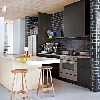 modern kitchen with black tiled wall