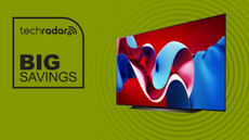 The LG C4 OLED TV next to a sign saying "Big Savings"