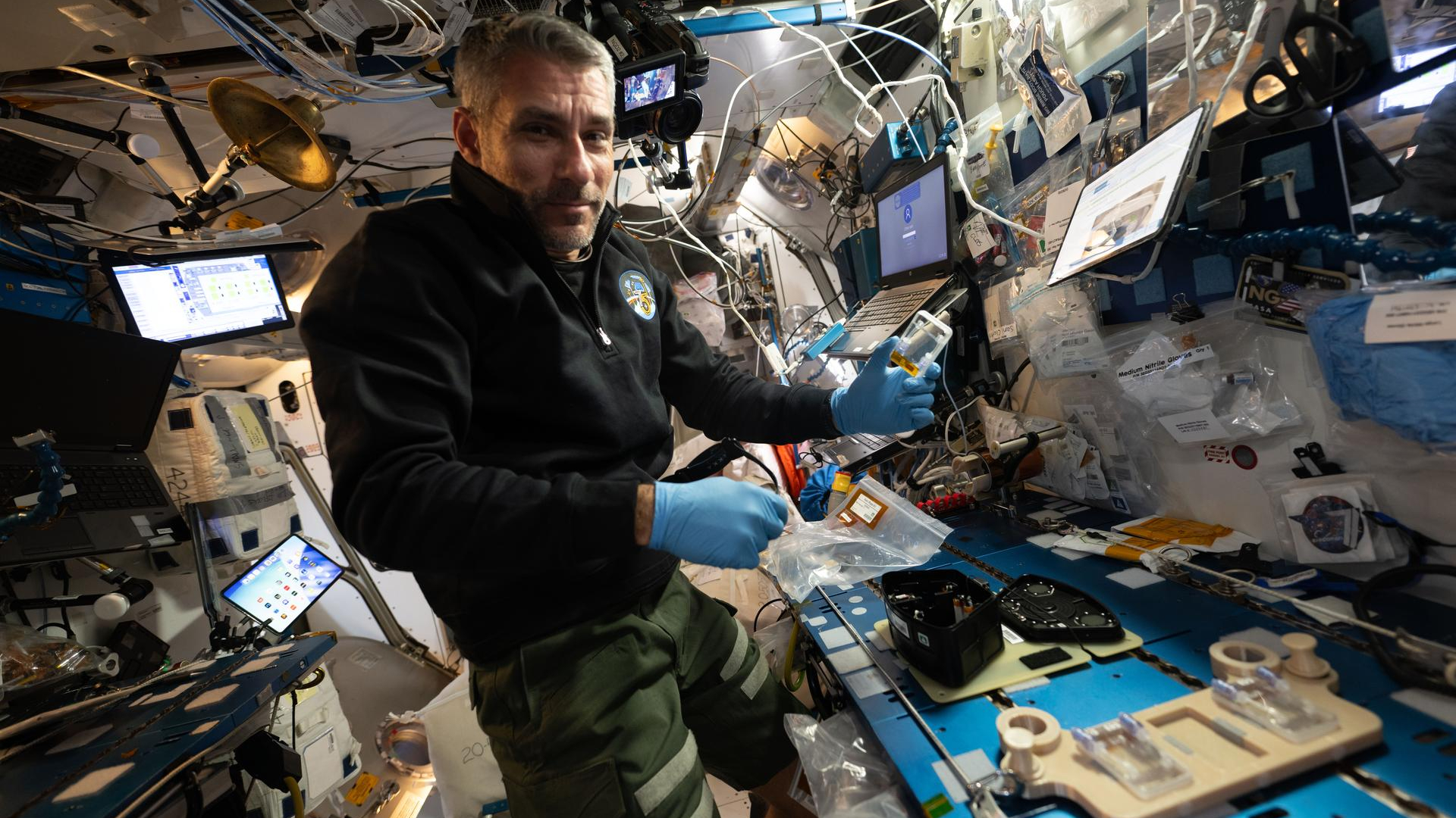 NASA astronaut Luke Delaney conducts botany experiments on the ISS.
