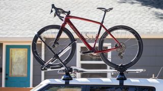 Thule Upride rack carrying a red Trek bike with carbon Hunt wheels