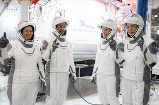 SpaceX’s Crew-1 astronauts — NASA's Shannon Walker, Victor Glover and Michael Hopkins and JAXA astronaut Soichi Noguchi — pose in front of their Dragon capsule, "Resilience," at SpaceX's headquarters in Hawthorne, California. 