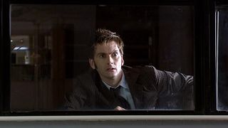 Tenth Doctor David Tennant looking through a window in Doctor Who episode "Partners in Crime"