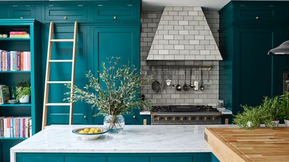 Turquoise kitchen with grey tiled extractor hood over range cooker