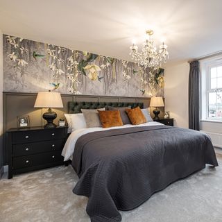 bedroom with designed wall chandelier bed with designed cushion and grey designed flooring