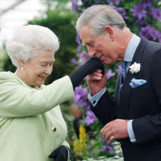 Queen Elizabeth II presents Prince Charles, Prince of Wales with the Royal Horticultural Society's Victoria Medal of Honour during a visit to the Chelsea Flower Show on May 18, 2009 in London. 