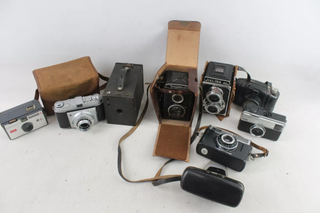 A selection of vintage cameras against a white background