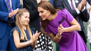 Catherine, Princess of Wales talks with Princess Charlotte of Wales in the Royal Box at the start of the Men's Singles Final at Wimbledon 2024