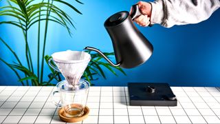 the all-black matte fellow stagg ekg kettle with an electric base and customizable temperature and a gooseneck spout, perfect for pour-over coffees