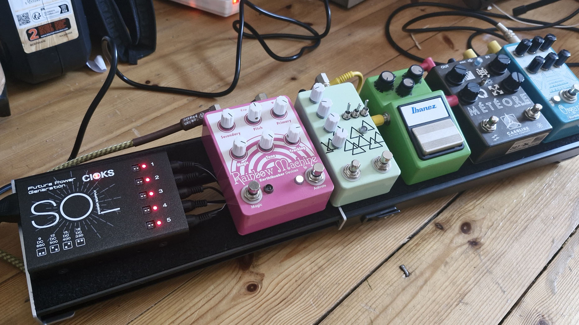 Cioks Sol Future Power Generation power supply mounted to a pedalboard alongside 5 pedals
