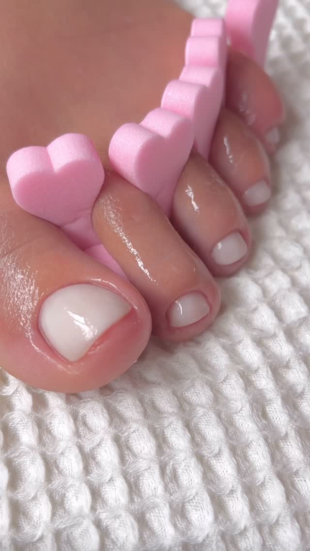 A pedicure with a sheer milky white nail colour