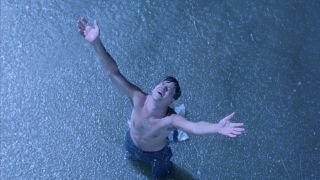 Tim Robbins arms raised in The Shawshank Redemption