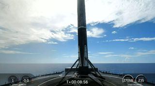 A SpaceX Falcon 9 rocket shortly after landing on a droneship at sea.