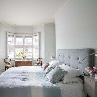 a calm new england feel suffuses the master bedroom.