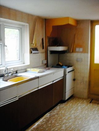 Before picture of kitchen with yellow walls and pattern lino floor