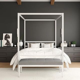 white four-poster bed in dark bedroom