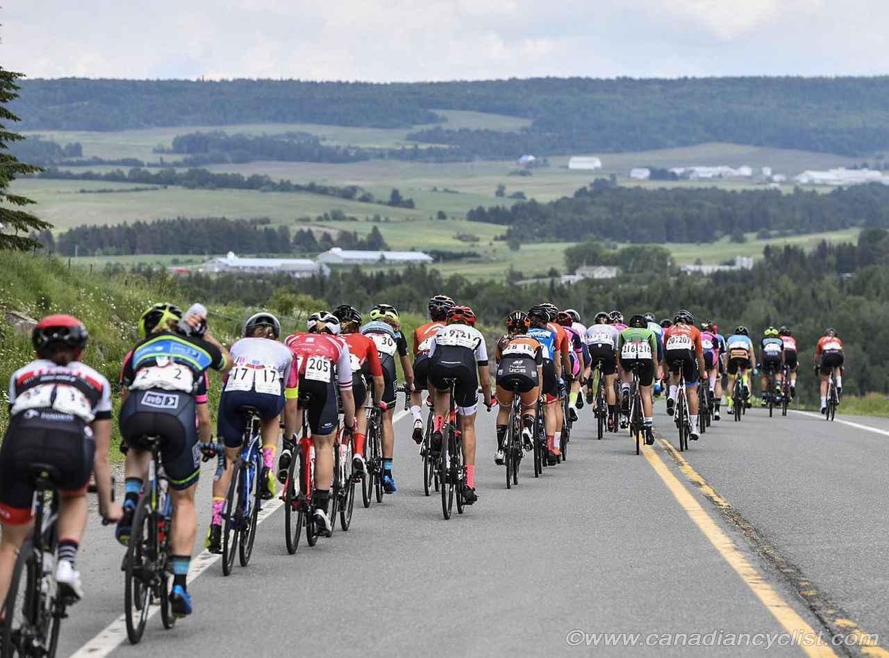 The peloton crests the main climb