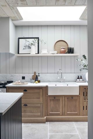 White kitchen, wooden kitchen base cabinets and black kitchen island