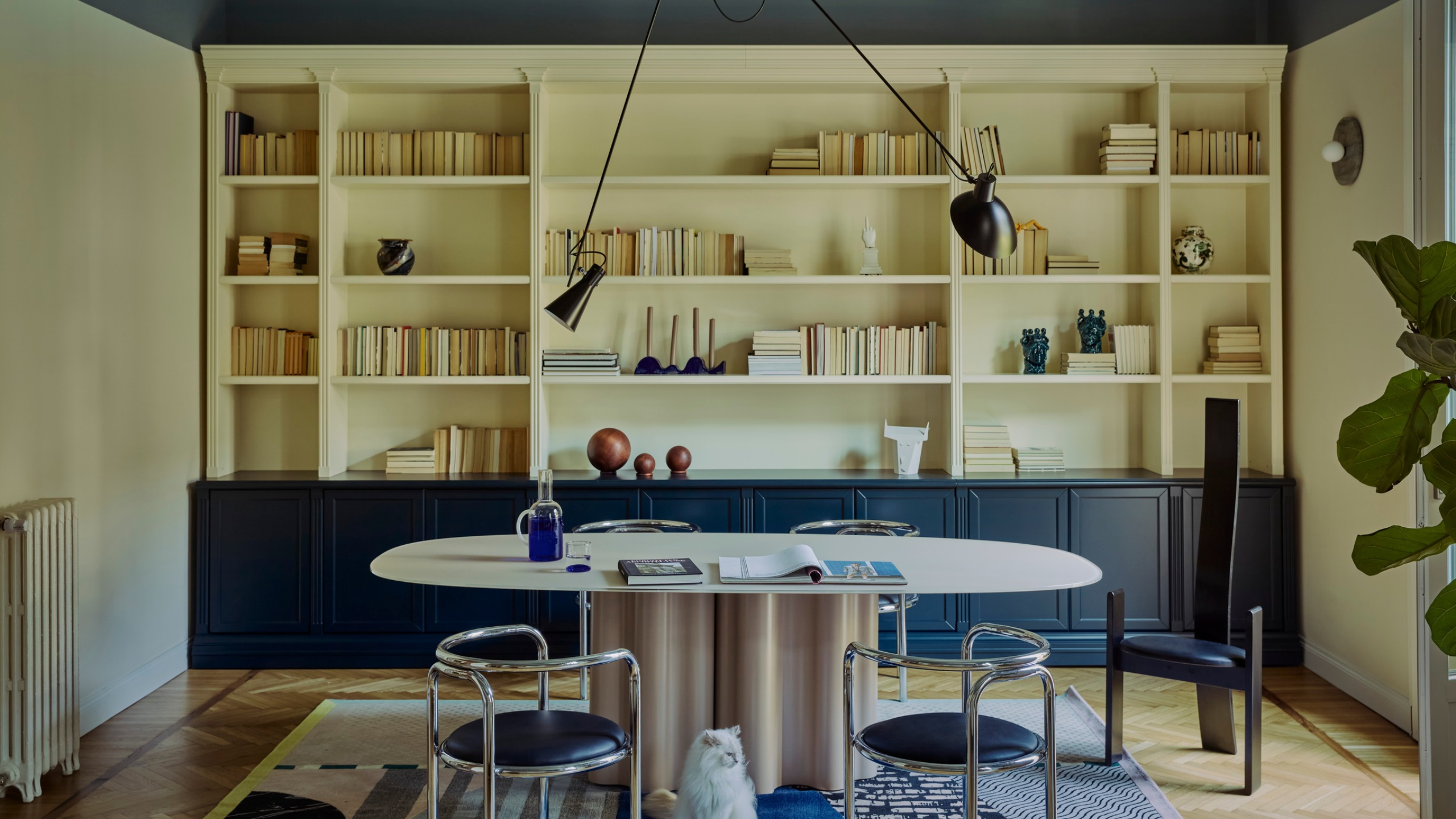 study with blue painted ceiling, modern chrome furniture, a blue rug, and large windows