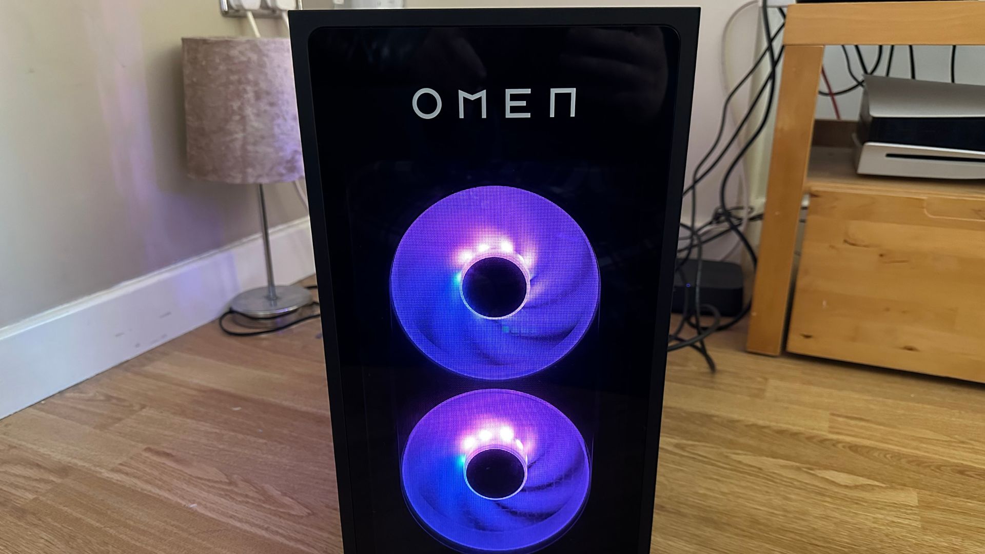 The HP Omen 35L in black, from the front, showing purple lighting on its fans