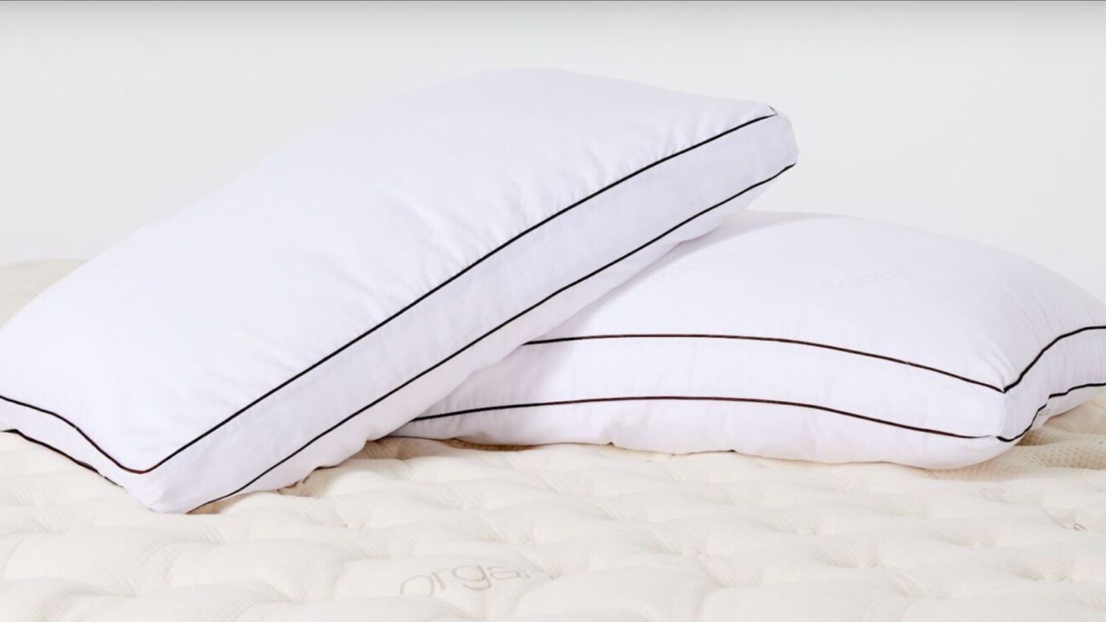Two pillows propped on a mattress