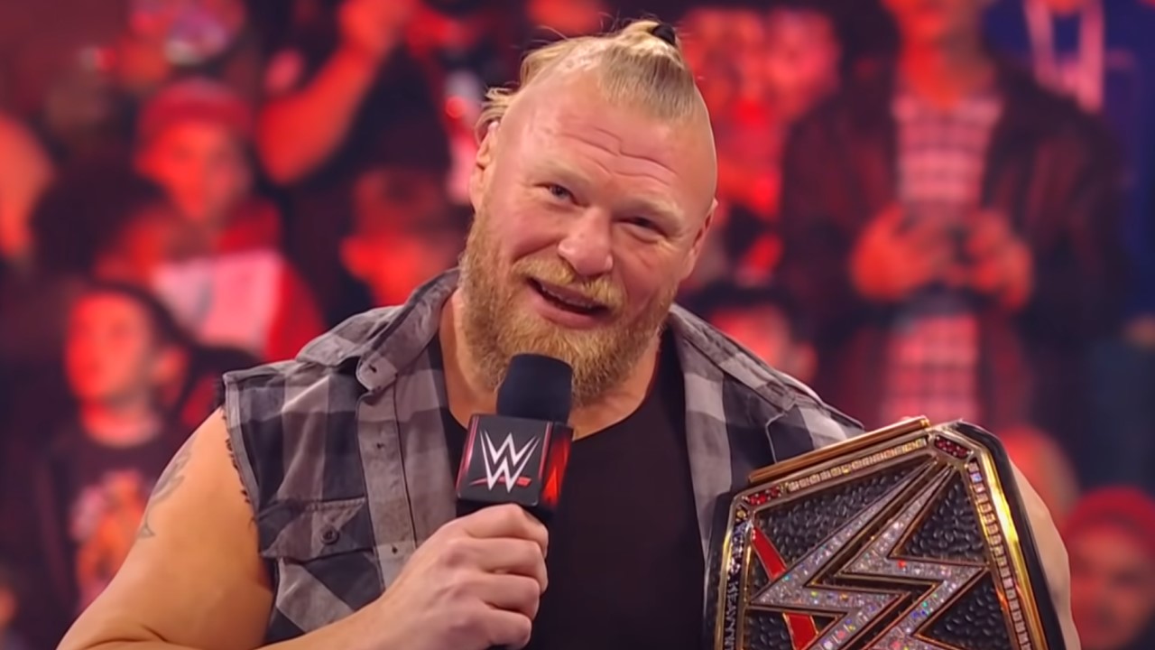 Brock Lesnar on the mic holding WWE championship belt 