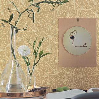room with printed yellow wallpaper and plant in vase