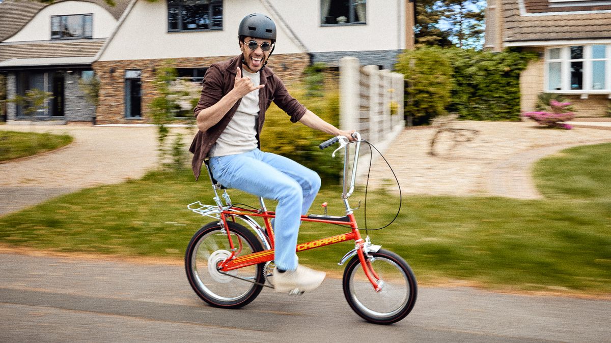 Raleigh Chopper bicycle being ridden down a street 