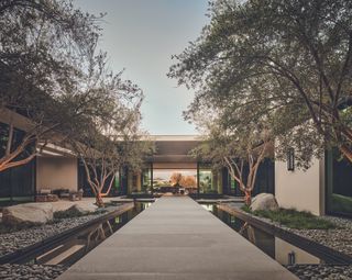 Entry courtyard with a water feature creates a zen atmosphere which runs through this desert house