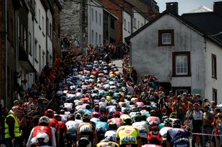 LIEGE BELGIUM APRIL 24 A general view of the peloton passing through the Cte de SaintRoch 456m in Houffalize City while fans cheer during the 108th Liege Bastogne Liege 2022 Mens Elite a 2572km one day race from Lige to Lige LBL WorldTour on April 24 2022 in Liege Belgium Photo by Bas CzerwinskiGetty Images