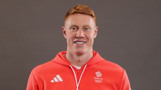 Tom Dean during the Team GB Paris 2024 wearing a red top and smiling