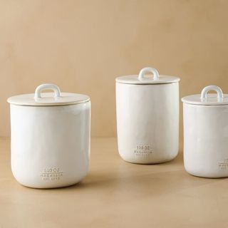 White ceramic storage jars with ceramic lids perched on top