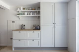pale grey kitchen with larger units and open shelving