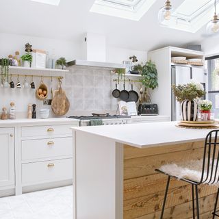 white kitchen with freestanding island with reclaimed wood panelling
