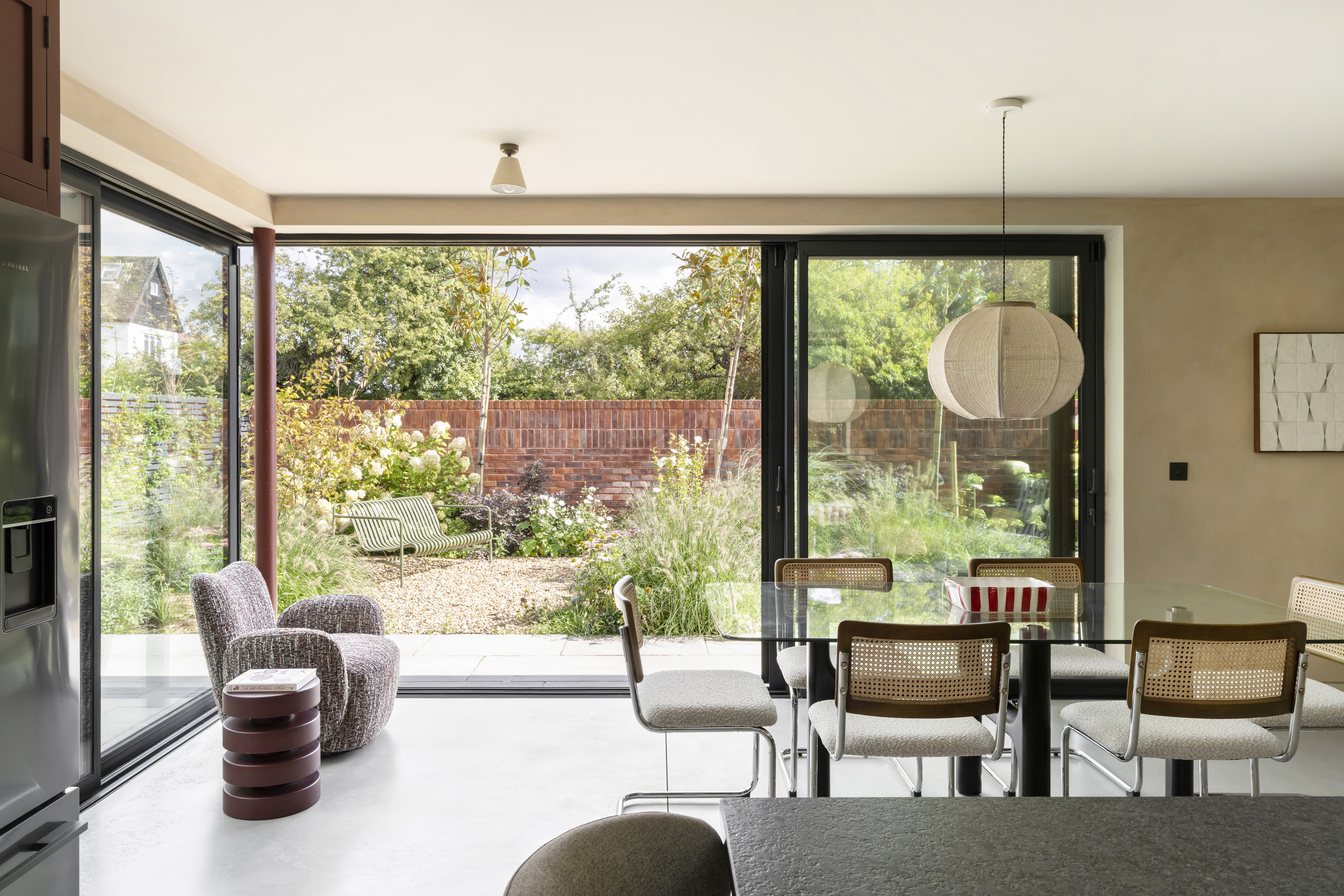view of interiors of Coeus London - Serene, a brick residential structure with a lush garden