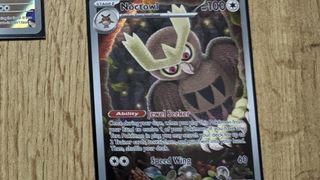 A Noctowl card on a wooden table