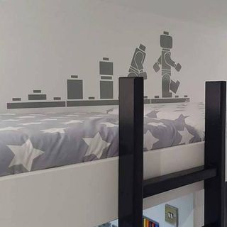 bedroom with lego revolution wall stencil and white wall
